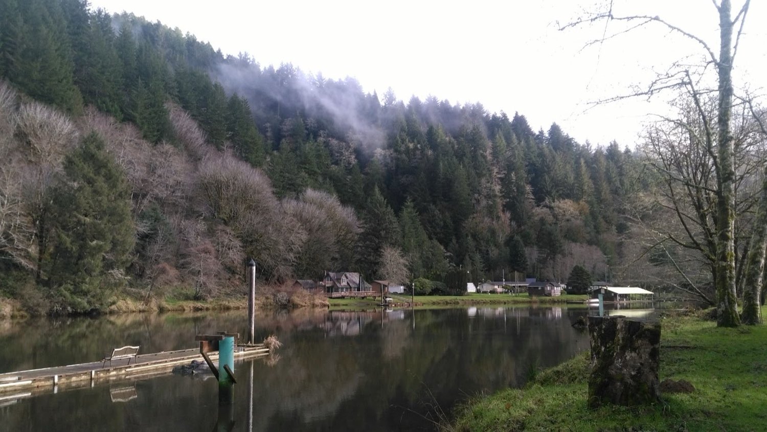 Morning fog over the Alsea River beside the park's dock
