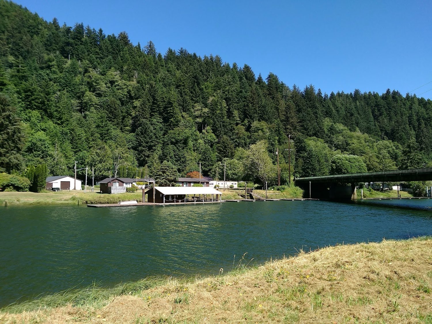 The Alsea River with the park's buildings and the Alsea Bay Bridge beyond